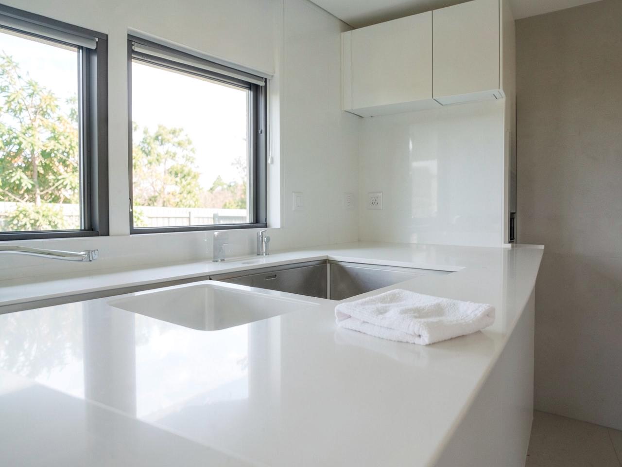 The same kitchen with clear, polished counters after cleaning